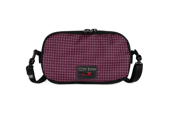 The Bantam in Acai 200 Halcyon with a shoulder strap